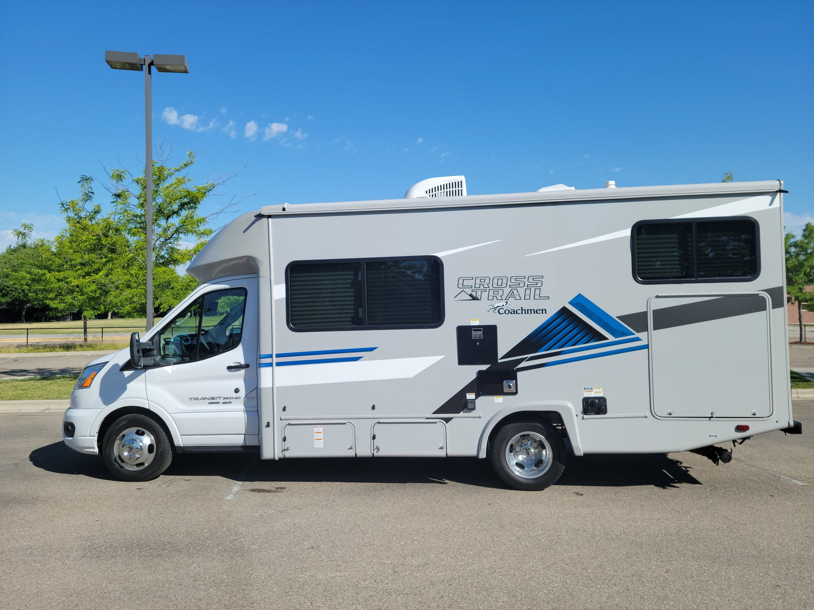 Sleek grey Coachmen Cross Trail Class C RV rental parked outdoors, ready for your next travel adventure.