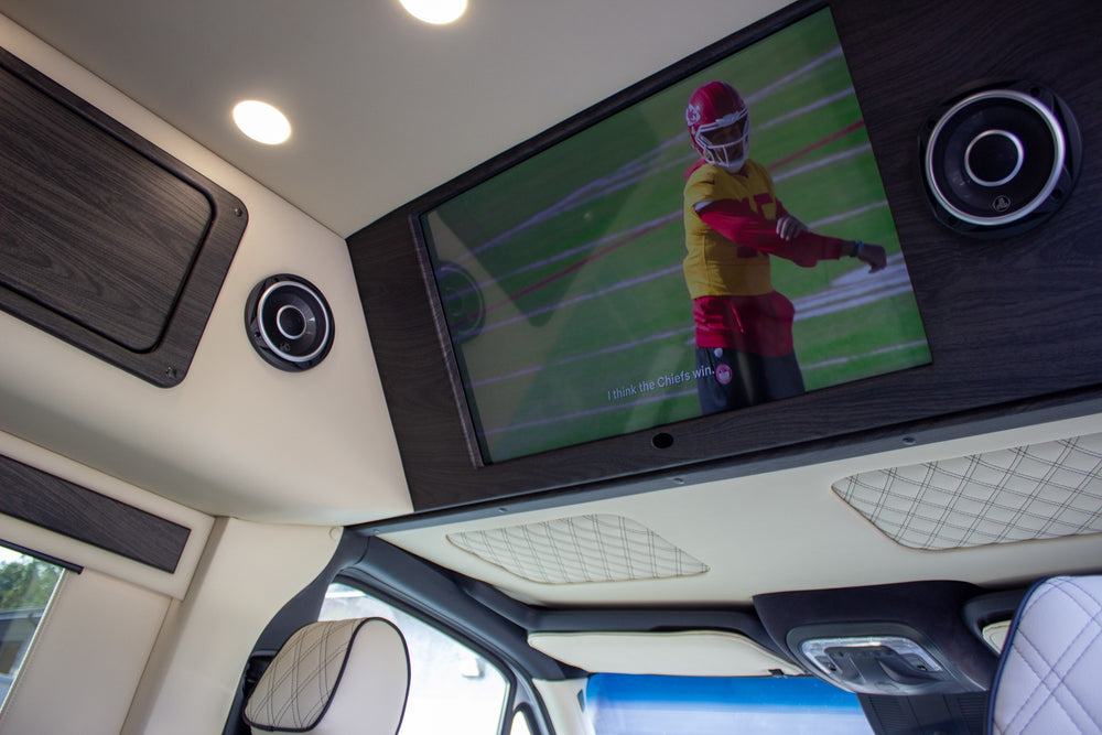 and plush quilted rear seating.|Compact RV rental kitchen featuring a sink