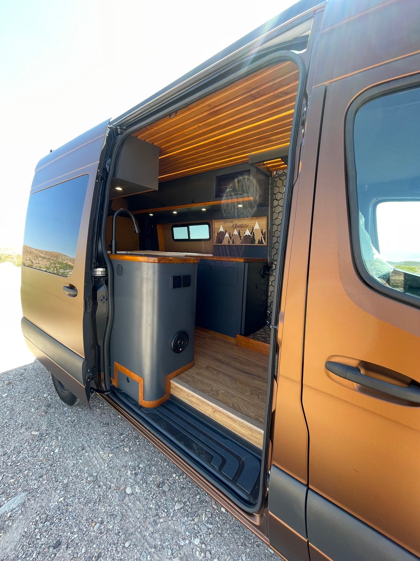 ready for adventure.|Spacious RV rental interior: custom camper van with modern kitchen
