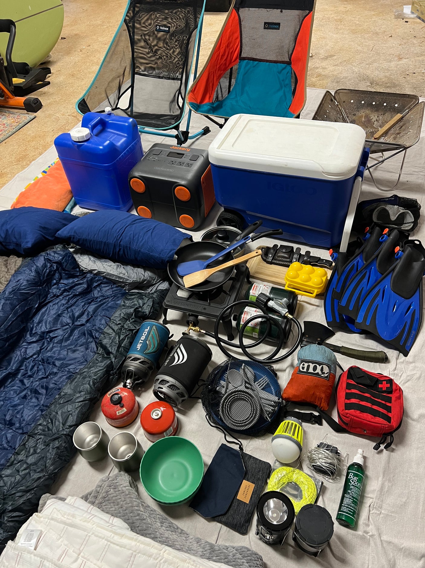 Camping & overlanding gear laid out: Helinox chairs, cooler, power, cooking, sleep, and dive essentials for your RV rental adventure.