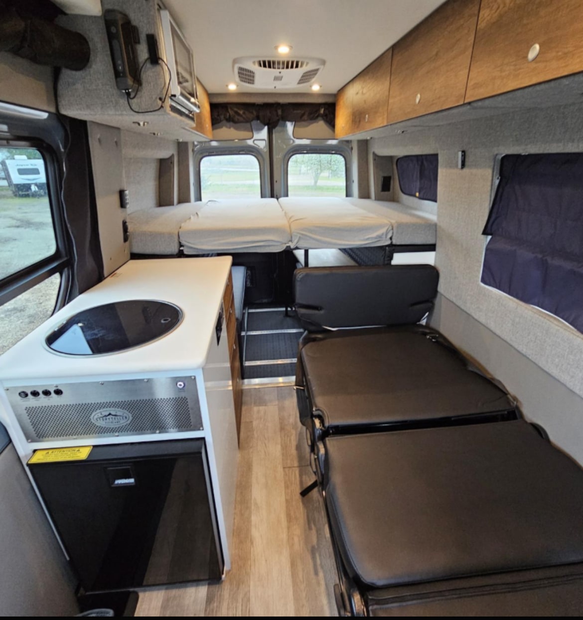 & Rockymounts bike rack. Perfect for outdoor adventures!|Interior of a modern rv rental camper van — photo 5