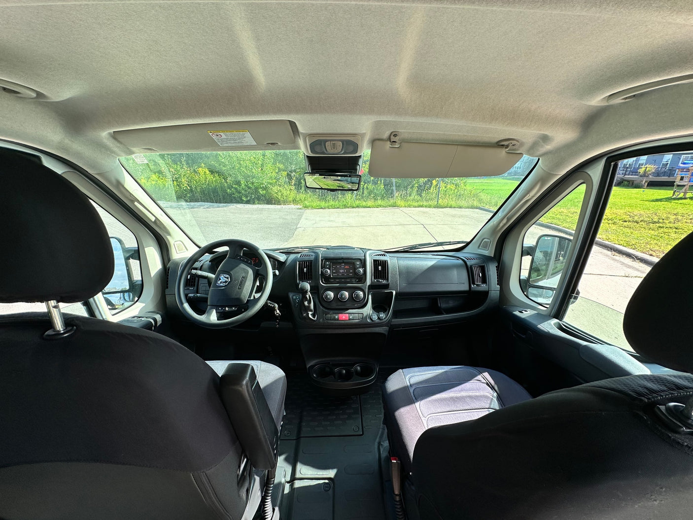 and a scenic view of a park outside.|Spacious RV rental cockpit
