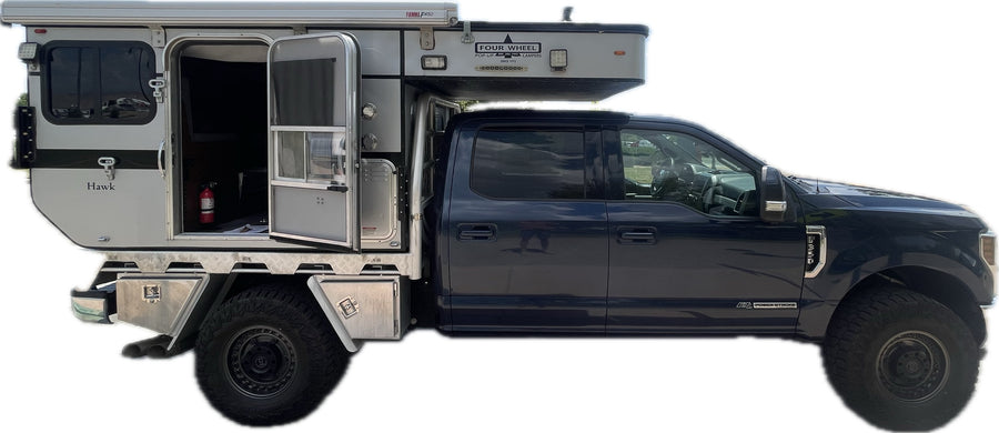 Side view: Ford F-350 pickup with a Hawk Four Wheel Pop-Up Camper. Consider this versatile RV for your next rv rental adventure.