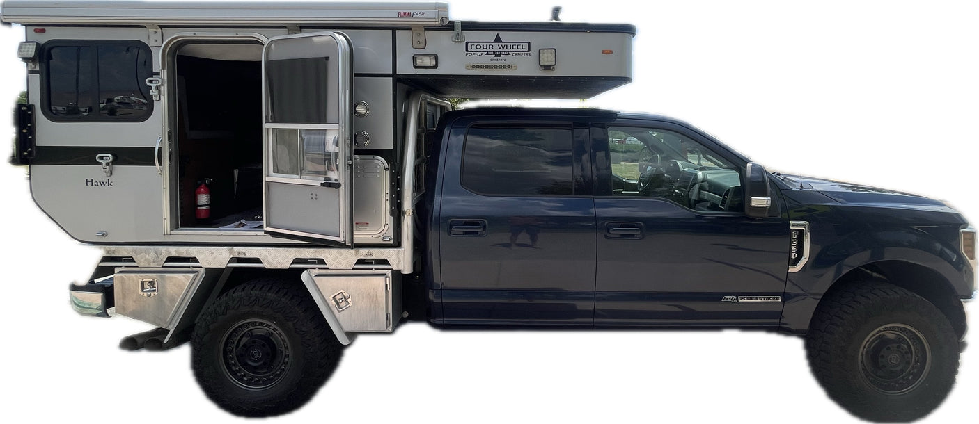Side view: Ford F-350 pickup with a Hawk Four Wheel Pop-Up Camper. Consider this versatile RV for your next rv rental adventure.