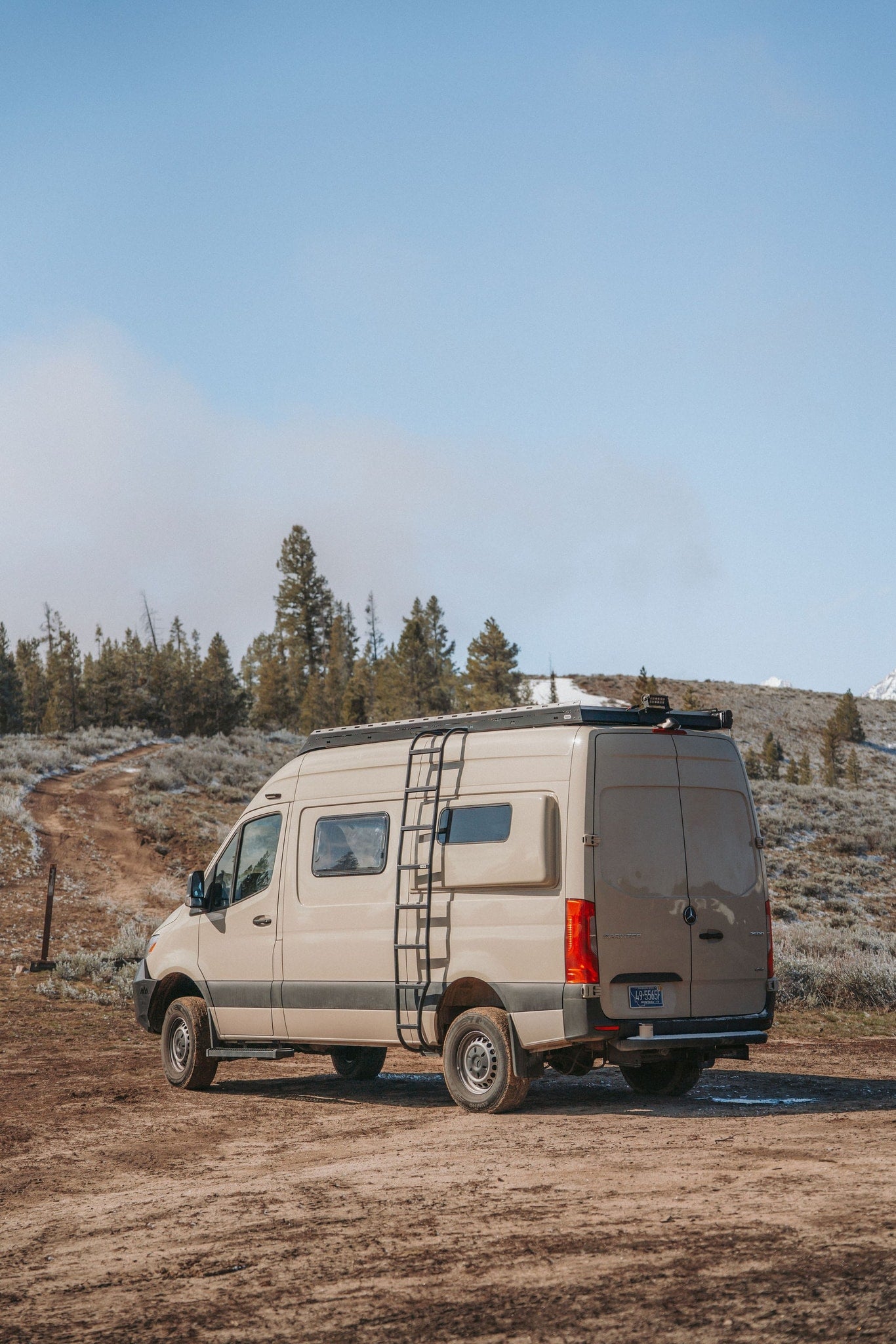 Adventure awaits! Tan Mercedes Sprinter rv rental on a dirt road