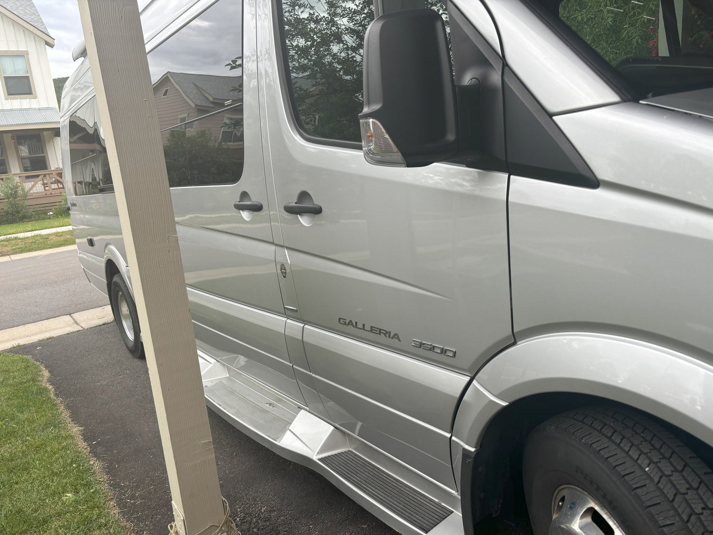 Silver Roadtrek Galleria 3500 camper van, seen from side. Great for your next rv rental road trip.