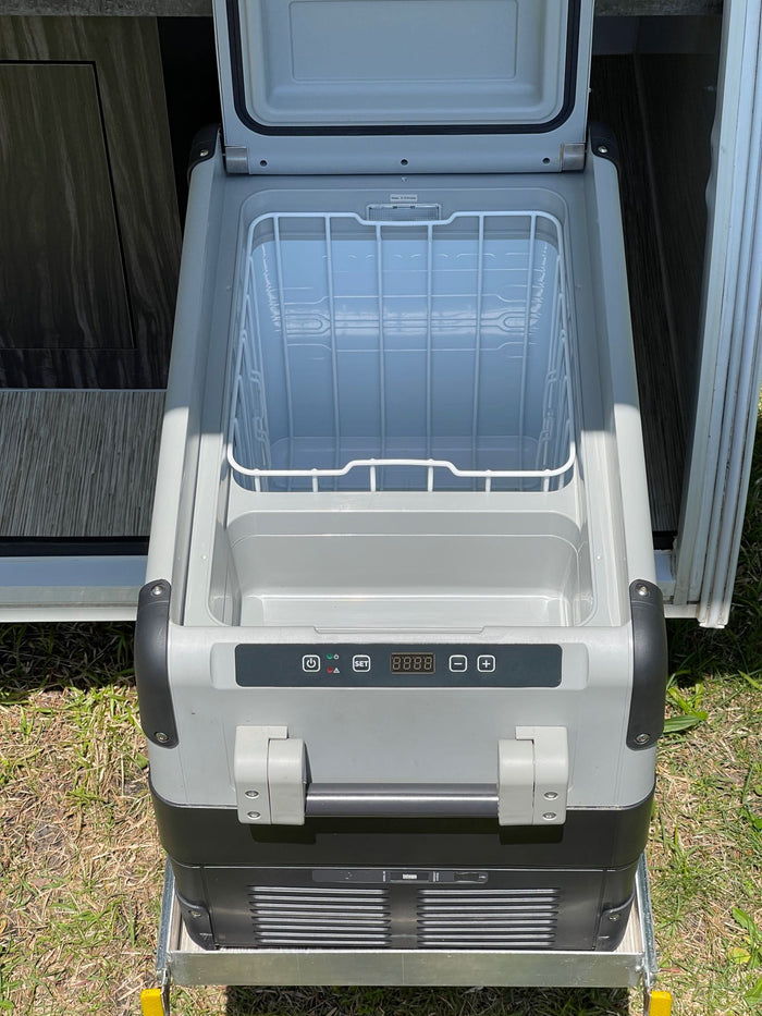 ready for adventure.|This white Luna teardrop RV camper with blue accents is ready for your next rv rental outdoor adventure.|This RV rental's compact outdoor galley features a sink