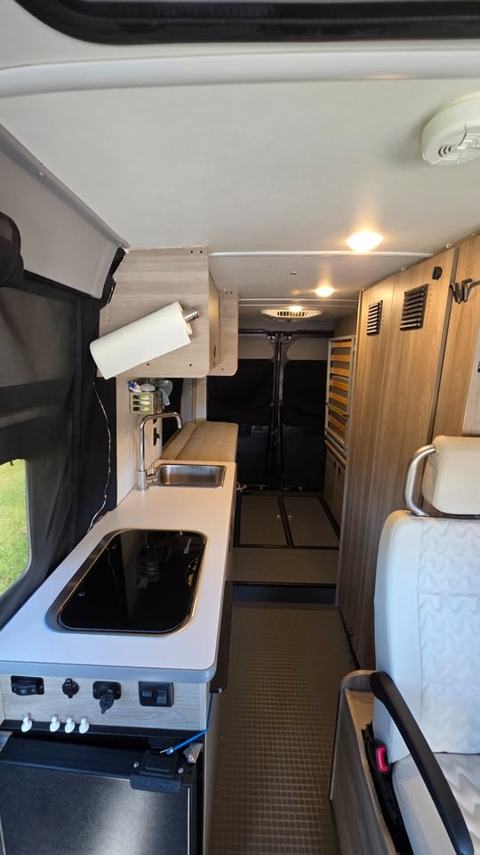 offering a comfortable sleeping area for your travels.|View inside an RV rental's pop-top
