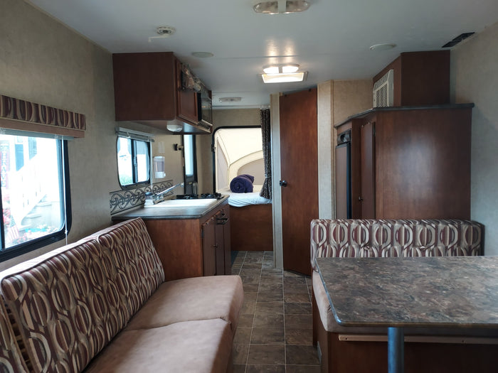 a hybrid travel trailer with awning extended & pop-out tent