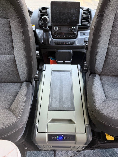 An optional portable electric cooler can be set to be a freezer or refrigerator. It sits between the two front seats when they are swiveled. Travels elsewhere in the van when driving.