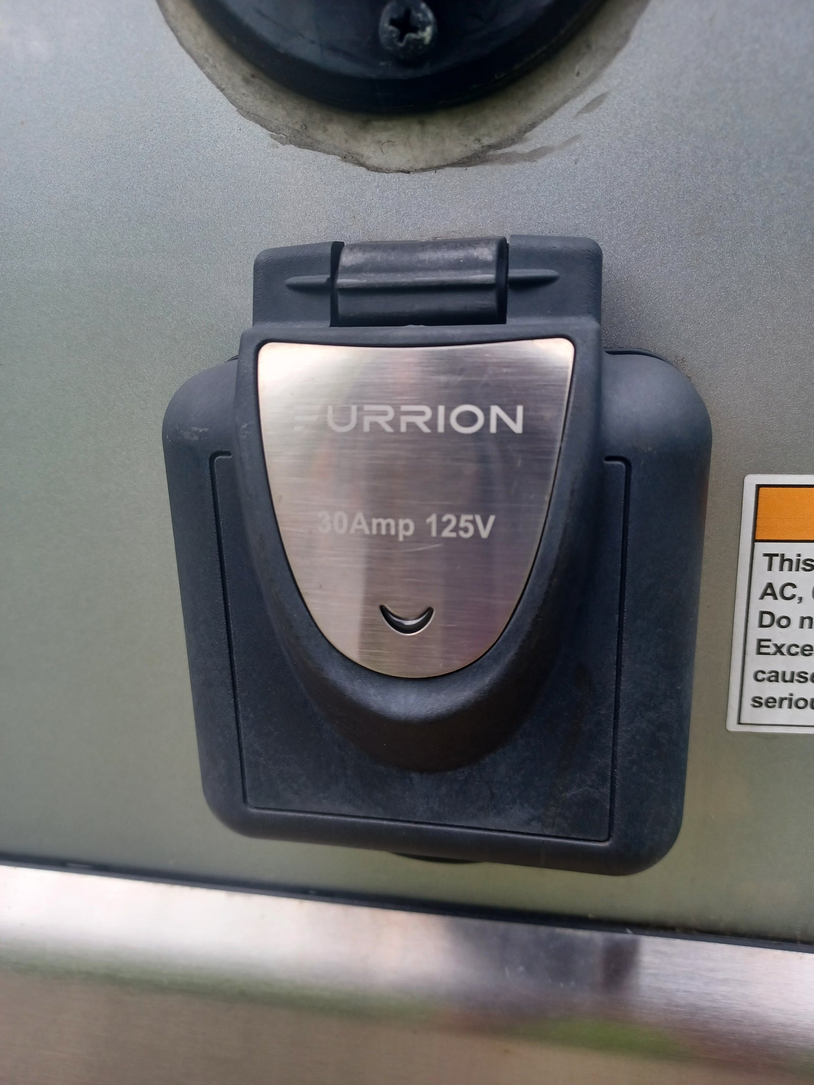 A FURRION 30Amp 125V RV power inlet, essential for connecting to shore power during your rv rental trip.