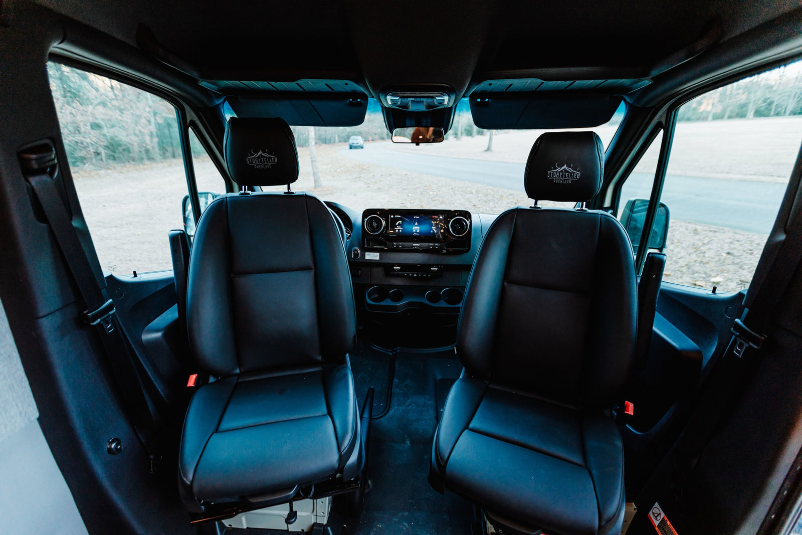 offering integrated sound and charging for your adventures.|Inside a Storyteller Overland RV rental: elevated bed