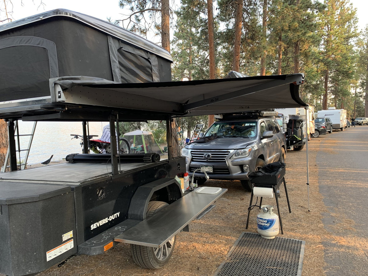 XV-2 set up at camp with the rooftop tent open and the 270-degree awning fully extended — photo 9
