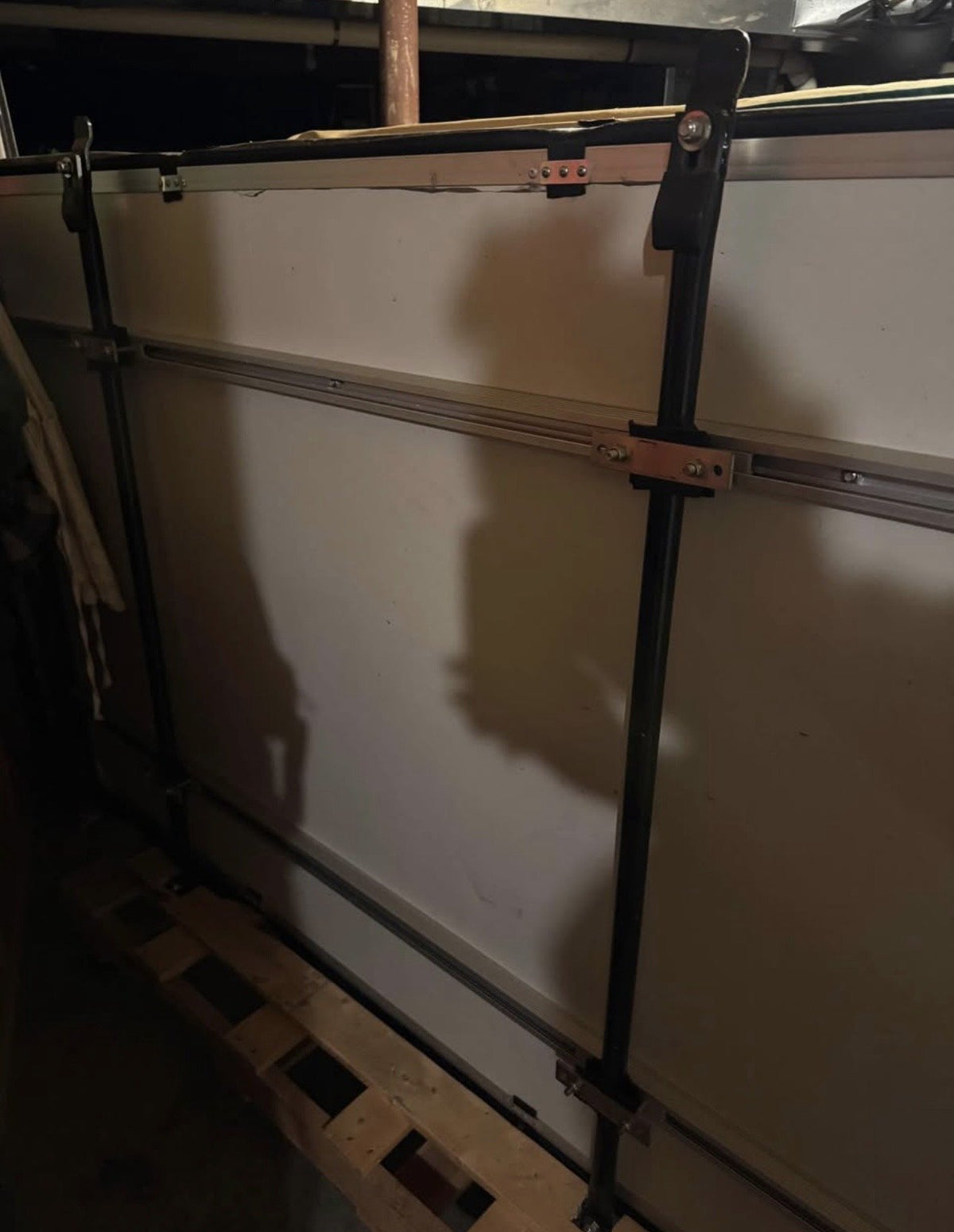 Underside of the folded tent showing the base panel and mounting rails — photo 9