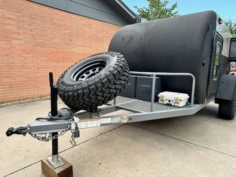 Front view with off-road hitch, tongue storage and swing-away spare tire