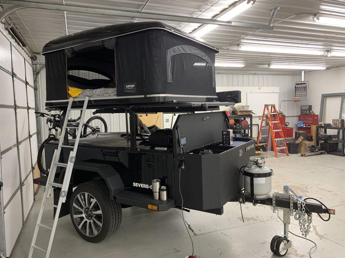 Airtop 360 rooftop tent open with the access ladder extended alongside the trailer — photo 7