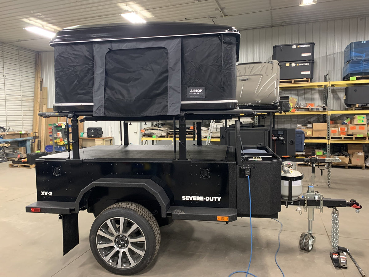 XV-2 with the rooftop tent opened, showing the XVENTURE galley boxes and full-length service table — photo 6
