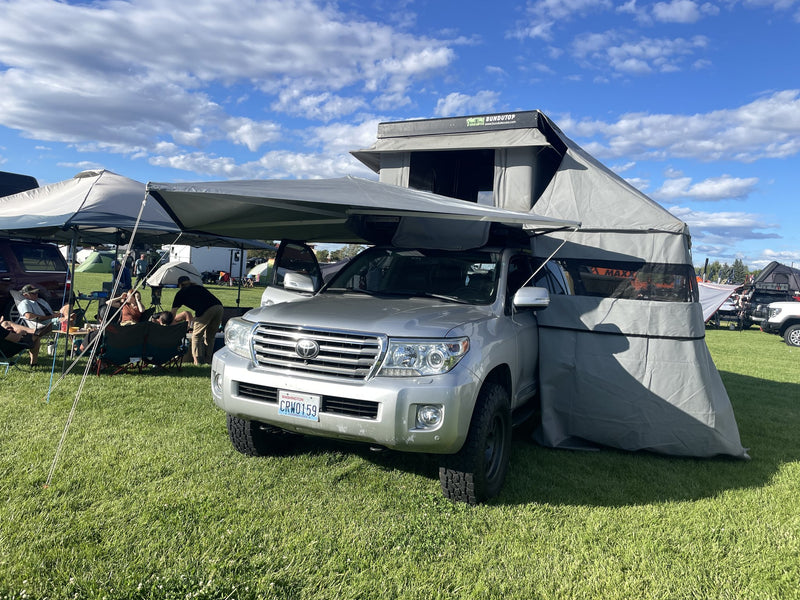 Rooftop tent and 270-degree awning deployed on the vehicle at a campground — photo 4
