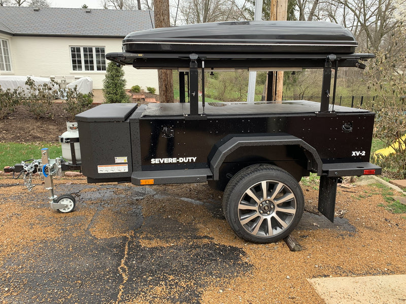 Passenger-side view of the XV-2 on a driveway with the awning mounted along the roof rack — photo 5