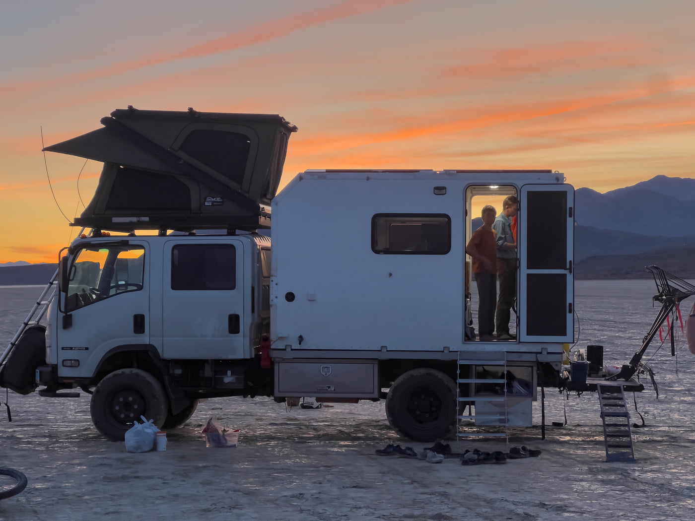 Isuzu NPR rig at dusk with entry stairs and door open — photo 9