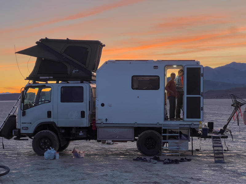 Isuzu NPR rig at dusk with entry stairs and door open — photo 9