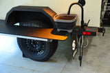 2014 Schutt Industries XVenture XV-2 overland trailer — upgraded alloy wheel with Cooper S/T Maxx tire beside the galley prep table