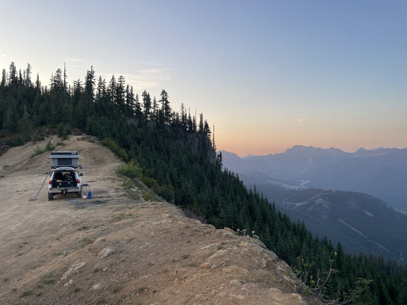 Vehicle with rooftop tent on a mountain ridge at sunset — photo 9