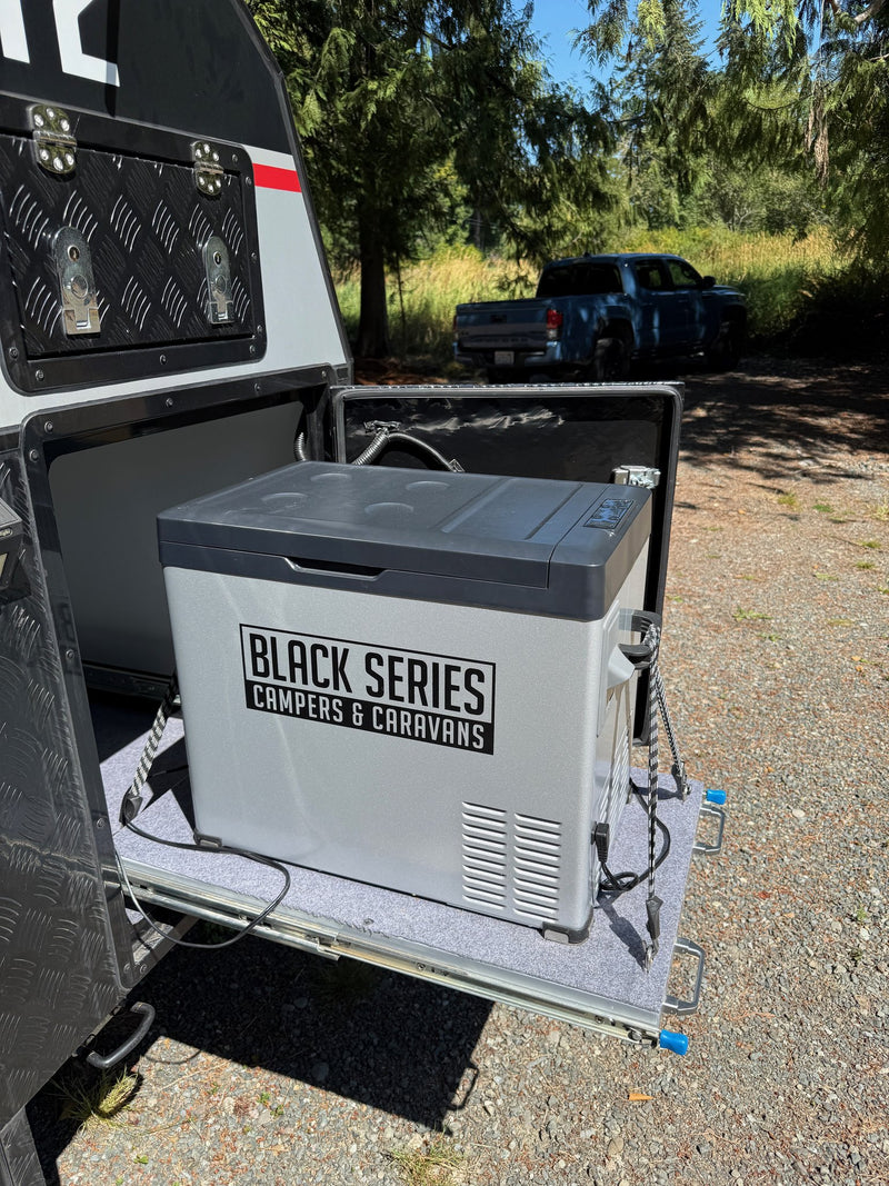 Black Series 12v camp fridge mounted on its slide in the exterior storage compartment — photo 7