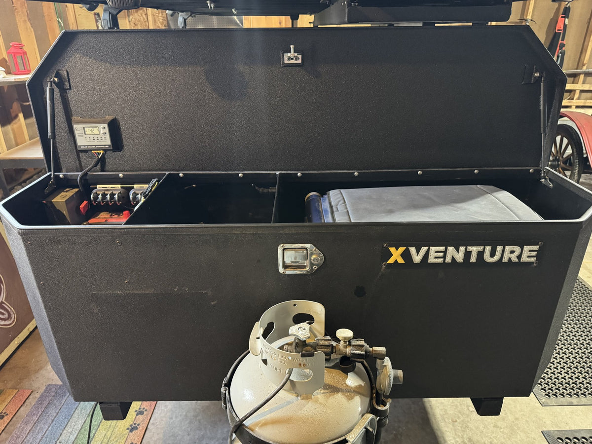 XVENTURE galley box open showing the interior storage compartment and the front-mounted propane tank — photo 17