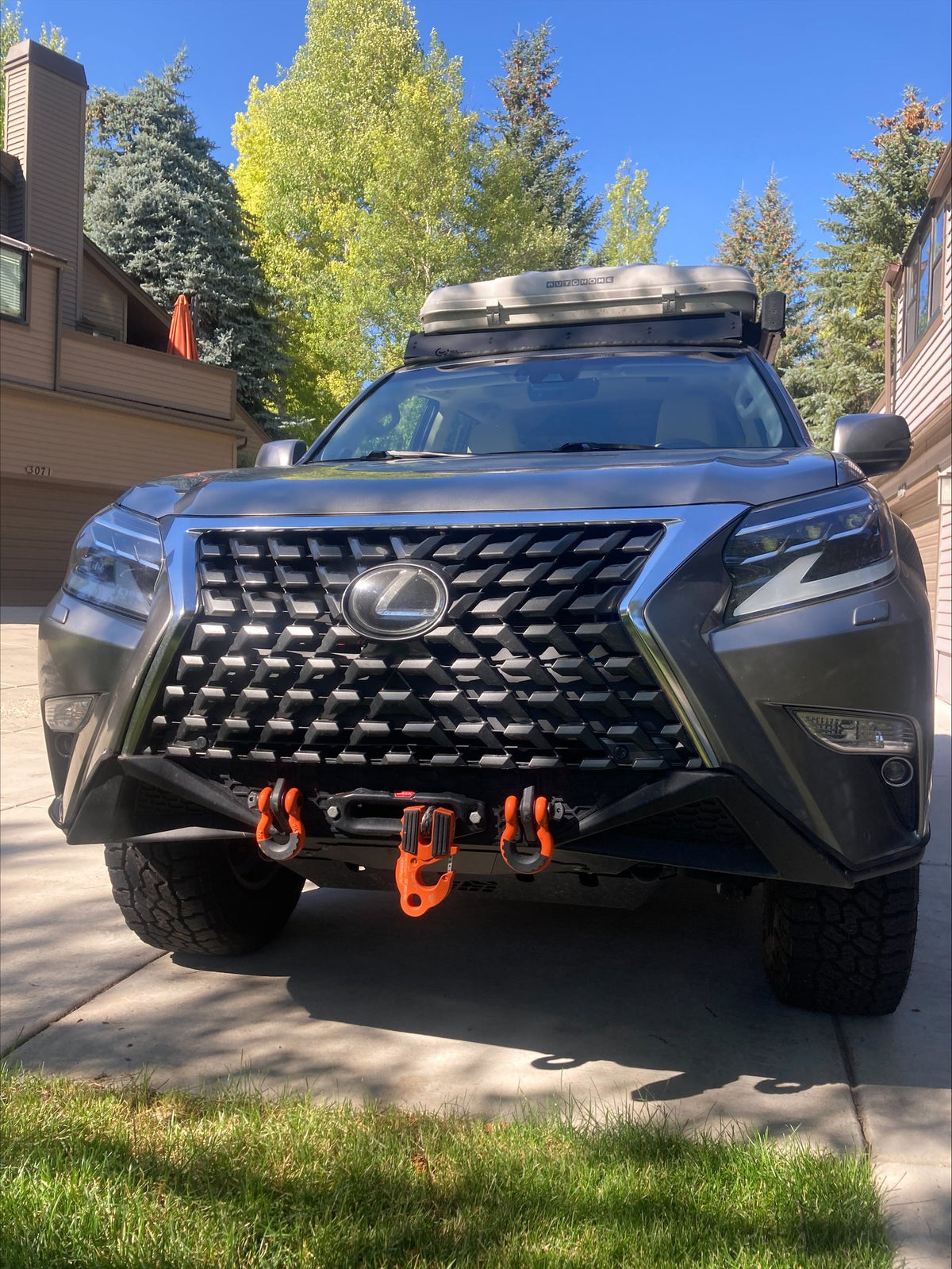 2021 Lexus GX460 head-on front view — CBI front bumper with Warn winch and orange recovery hooks, Lexus grille, Autohome rooftop tent on the roof rack — photo 3