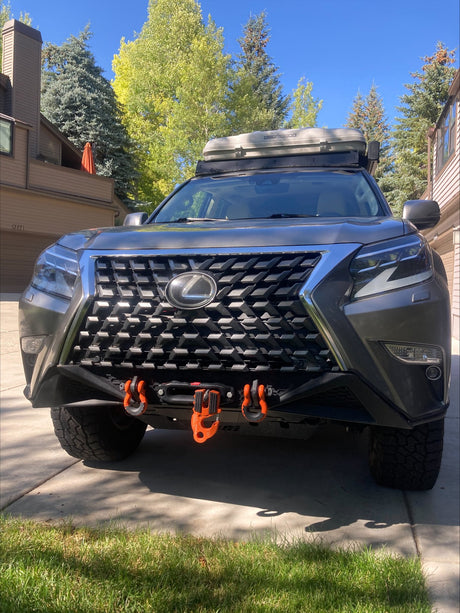 2021 Lexus GX460 head-on front view — CBI front bumper with Warn winch and orange recovery hooks, Lexus grille, Autohome rooftop tent on the roof rack