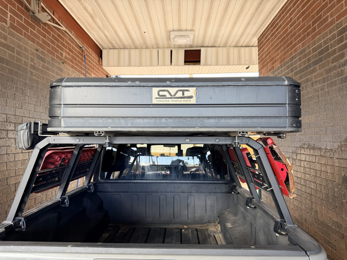 Aluminum hardshell closed for travel, rear view with the CVT Cascadia Vehicle Tents badge — photo 4