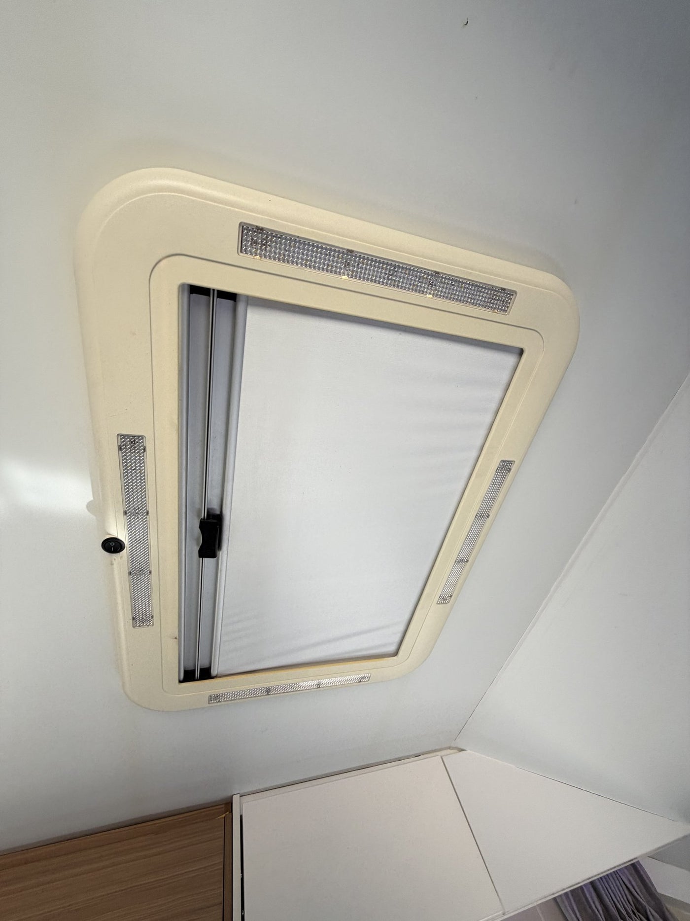 Ceiling hatch and roof vent from inside with the blind partially drawn and the LED surround lights — photo 20