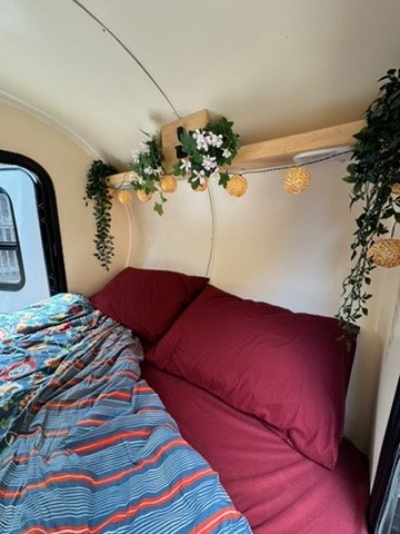 Cabin interior with queen bed and side window