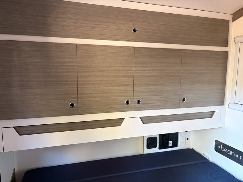 Interior wood cabinetry and overhead storage — photo 11