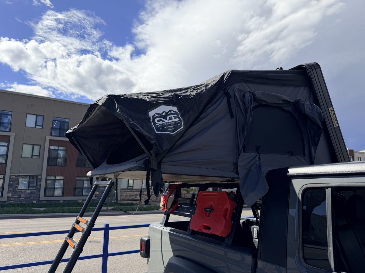 CVT Mt Washington hardshell rooftop tent open on a Jeep Gladiator with the telescoping ladder deployed — photo 1