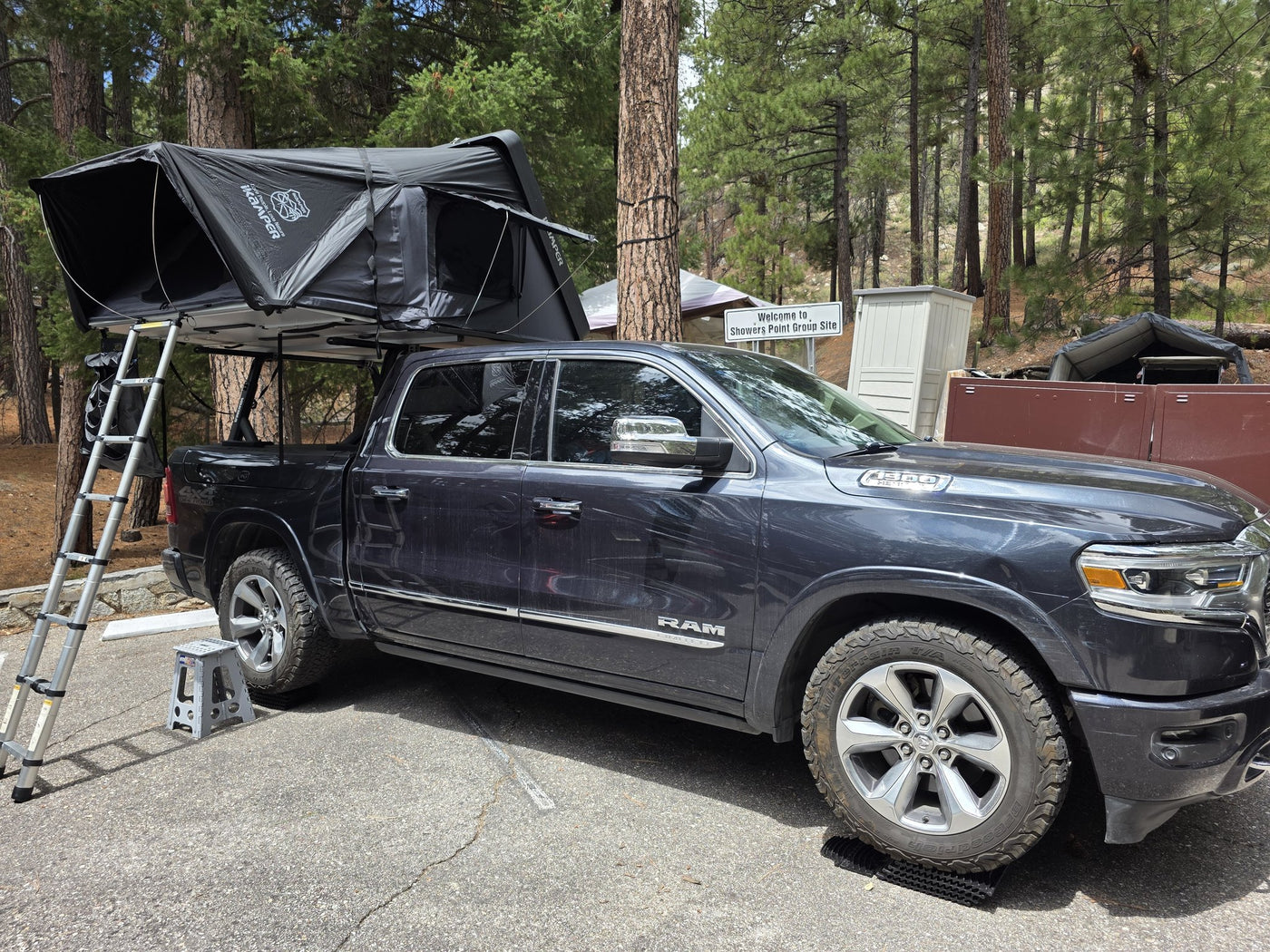 Side profile of the iKamper DLX rooftop tent deployed on the truck with the telescoping ladder down — photo 2