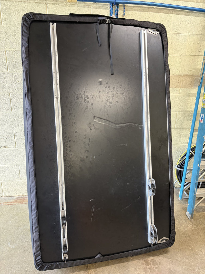 Underside of the closed tent showing the aluminium mounting rails, the padded edge trim and the cosmetic scuffs and light scratches on the shell described by the seller — photo 8