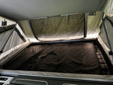 Interior fold-out queen bed under the tent canopy