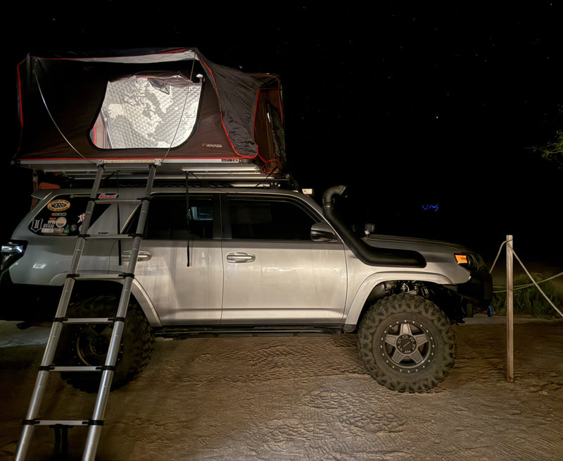 iKamper rooftop tent deployed at a night campsite — photo 11
