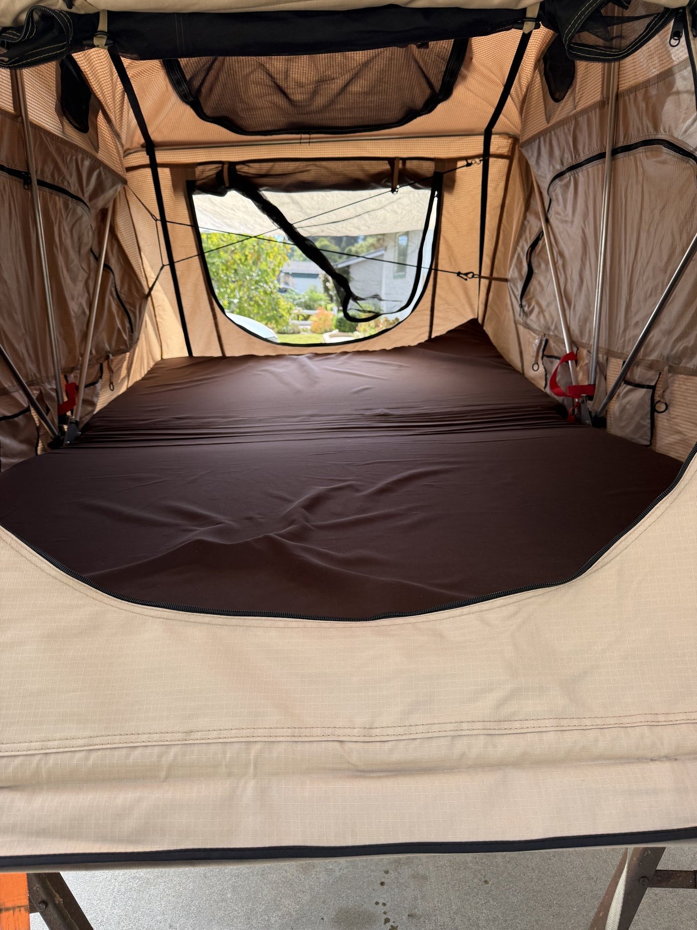 Interior of the tent showing the queen foam mattress, support poles, mesh ceiling vents and side windows — photo 8