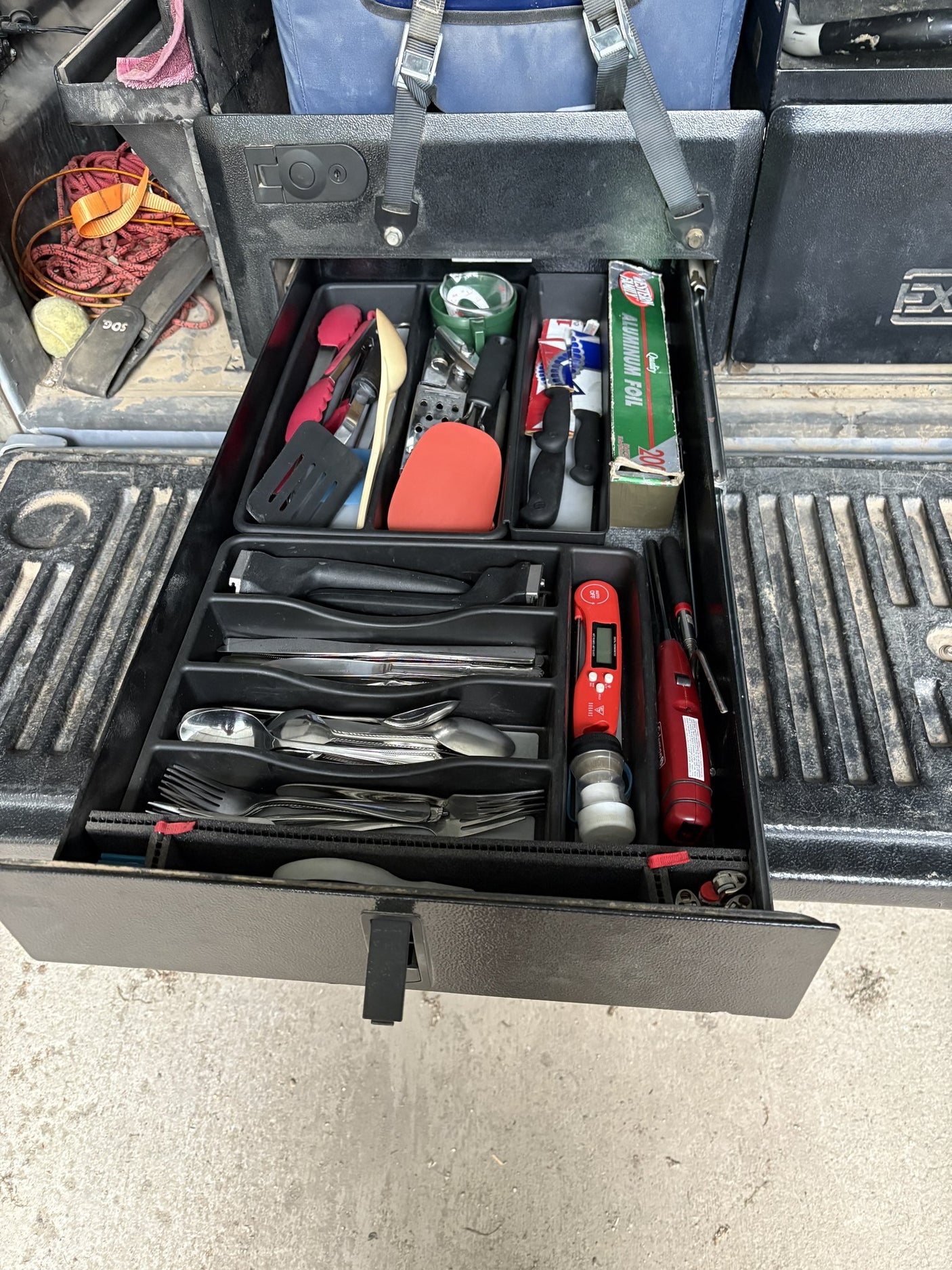 Utensil drawer open, showing the adjustable foam organizer dividers holding silverware, cooking tools and small kitchen items