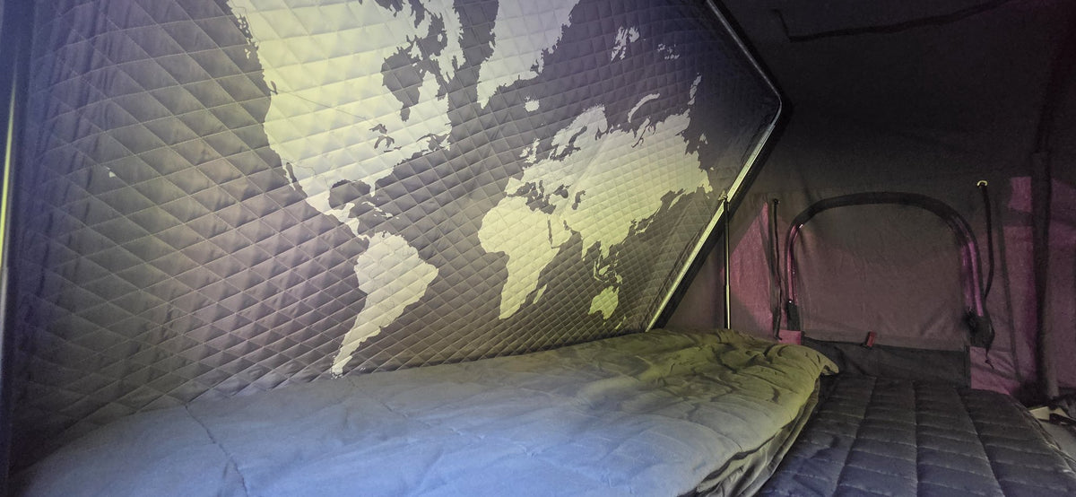 Interior quilted world-map insulation panel and mattress inside the Skycamp 3.0 — photo 6