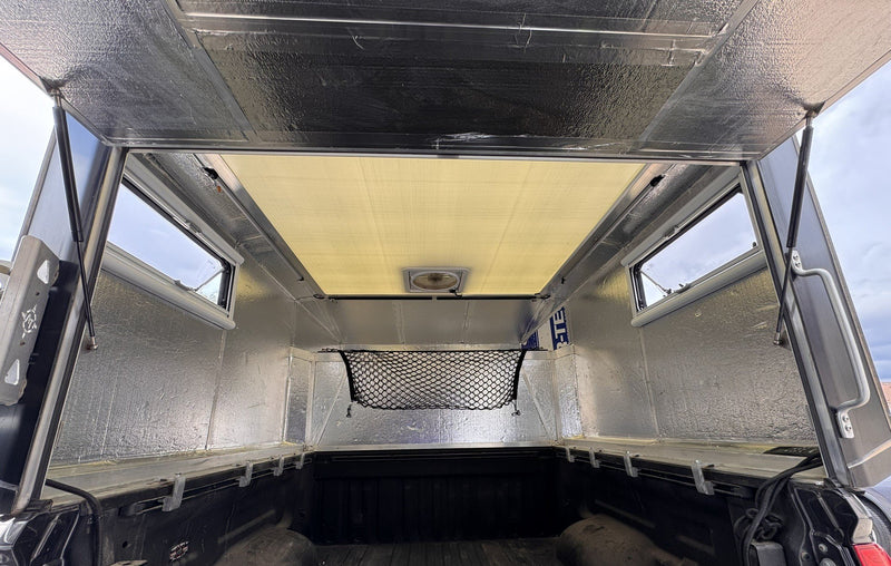 Interior of the Moonlander X looking toward the front, with insulated panels, Arctic Tern windows, cargo net and roof fan — photo 8