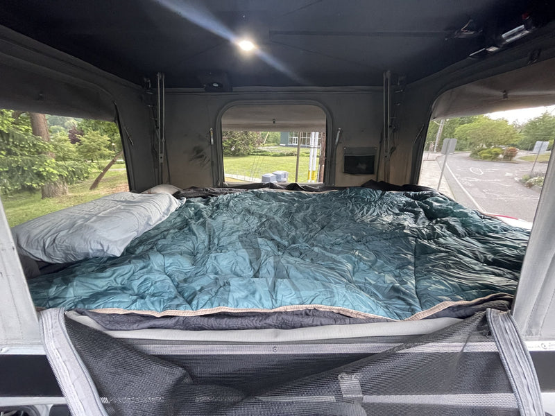 Interior of the rooftop tent showing the mattress and sleeping area — photo 5