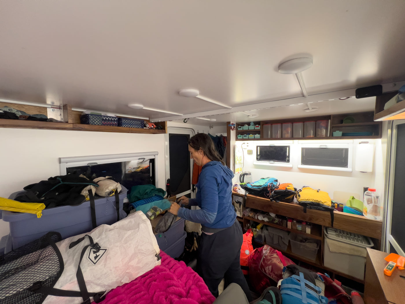 Camper habitat interior with storage and gear — photo 6