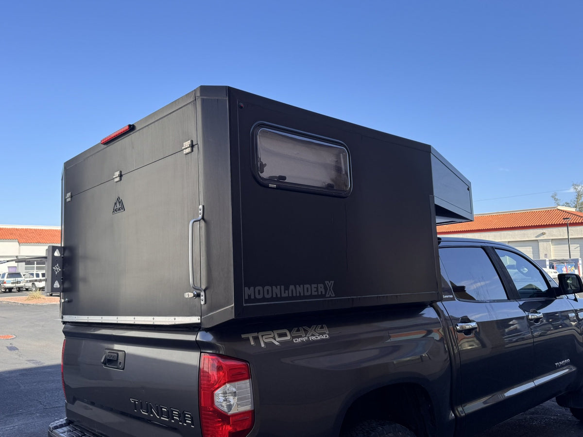 Rear view of the Moonlander X camper with the rear hatch closed, showing the insulated window and grab handle — photo 5