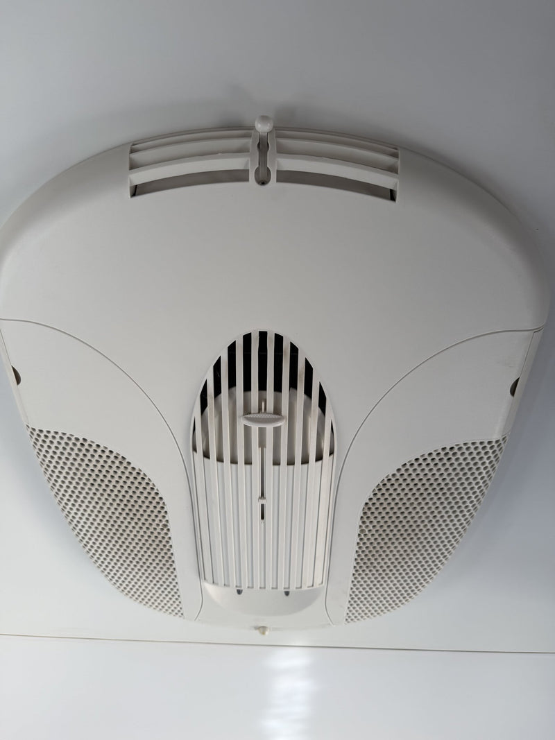 Roof-mounted air conditioner interior vent and diffuser on the white ceiling panel — photo 19