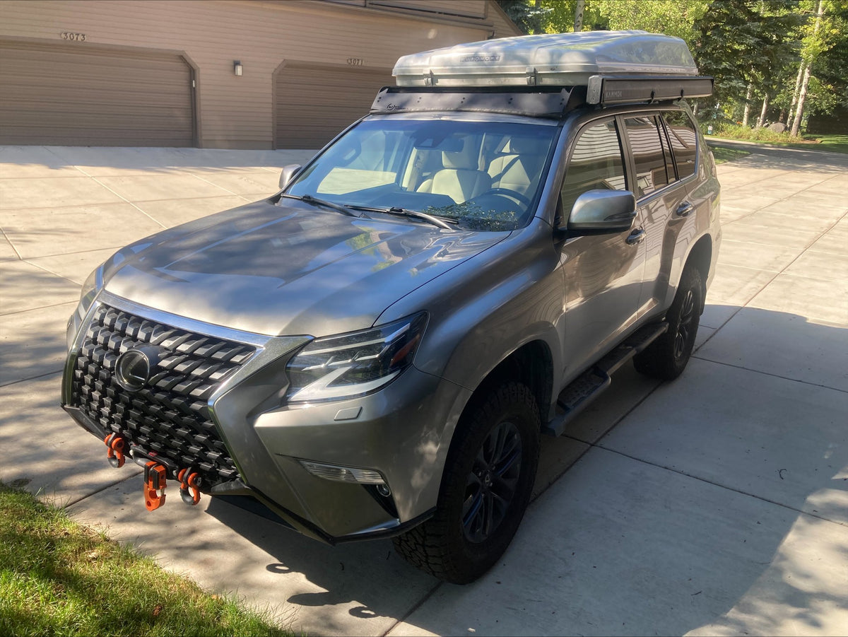 2021 Lexus GX460 front driver-side three-quarter view — Prinsu roof rack with Autohome rooftop tent and Kammok awning, CBI front bumper, black wheels on all-terrain tires — photo 2