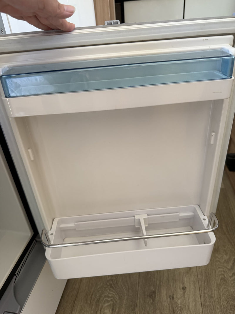 Refrigerator with the door open showing the empty clean interior, door shelf and crisper tray — photo 14